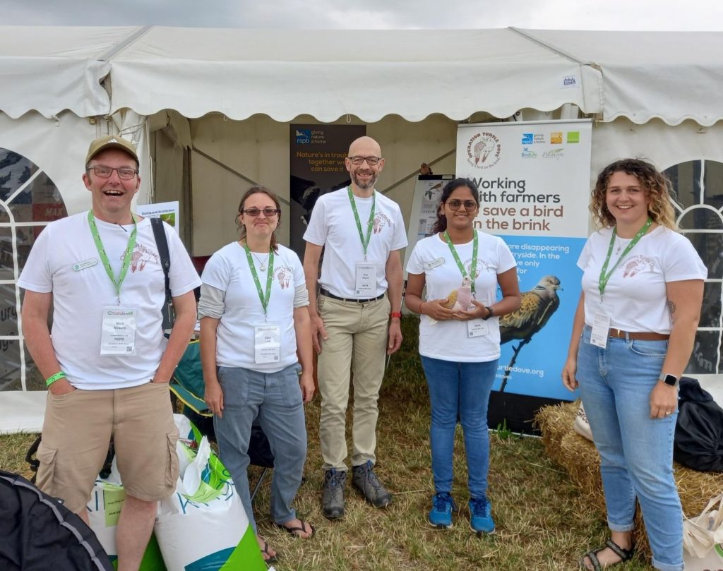 Operation Turtle Dove team standing outside marquee at Groundswell 2023. 