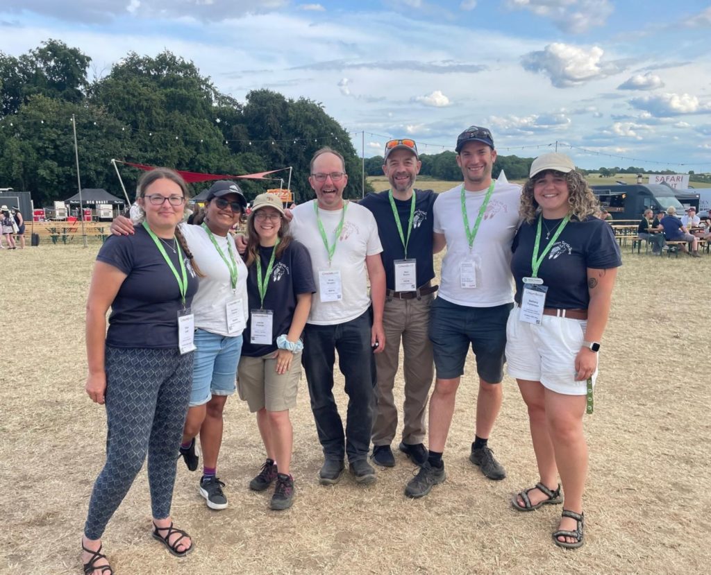 Seven members of the Operation Turtle Dove team standing at the Groundswell regenerative farming festival 2025