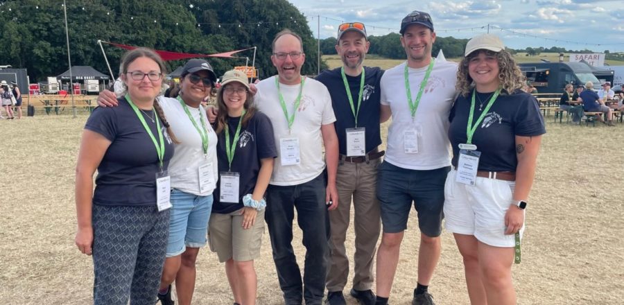 Seven members of the Operation Turtle Dove team standing at the Groundswell regenerative farming festival 2025